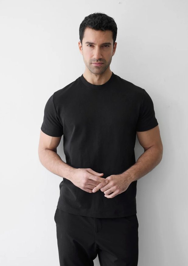 Example digital of a male model: natural light, plain background, no filters