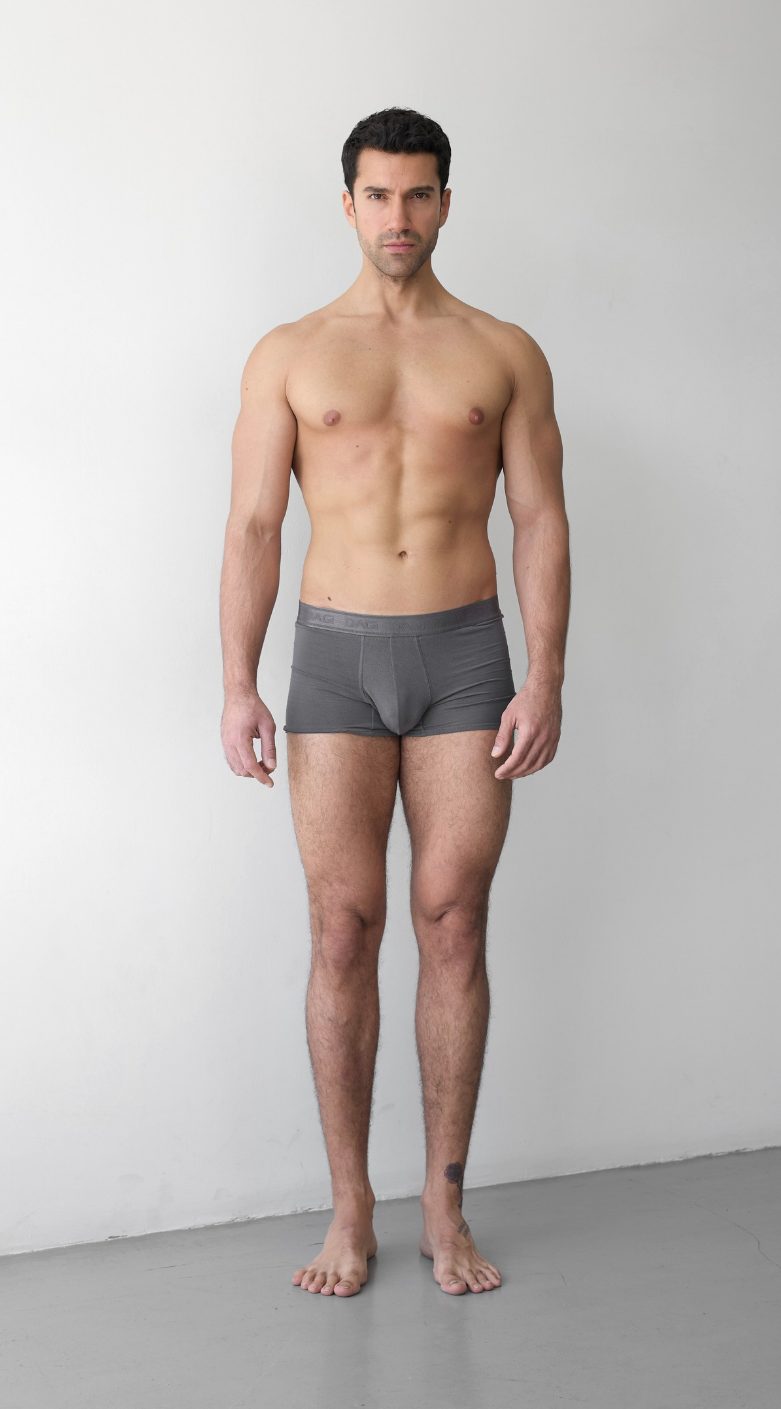 Full-body digital of a male model, front view, head to toe against a plain wall