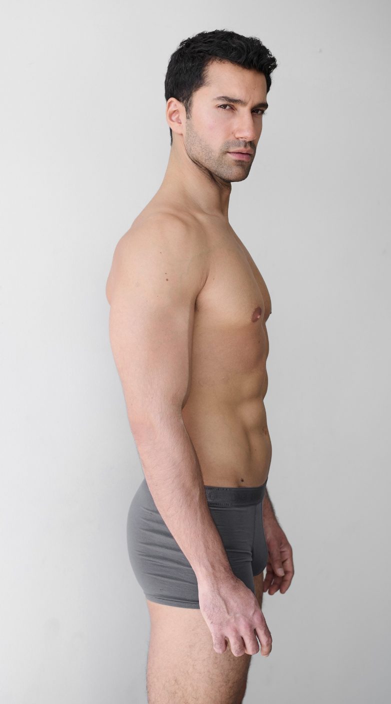 Half-body digital of a male model, other side view, plain background