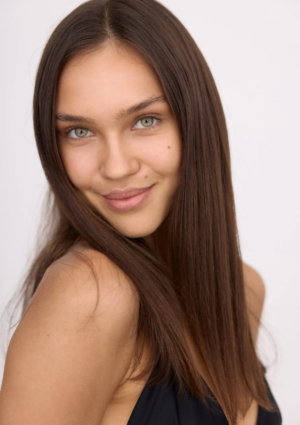 Example digital of a female model: natural light, plain background, no filters