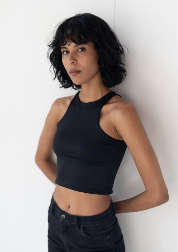 Example digital of a female model: natural light, plain background, no filters