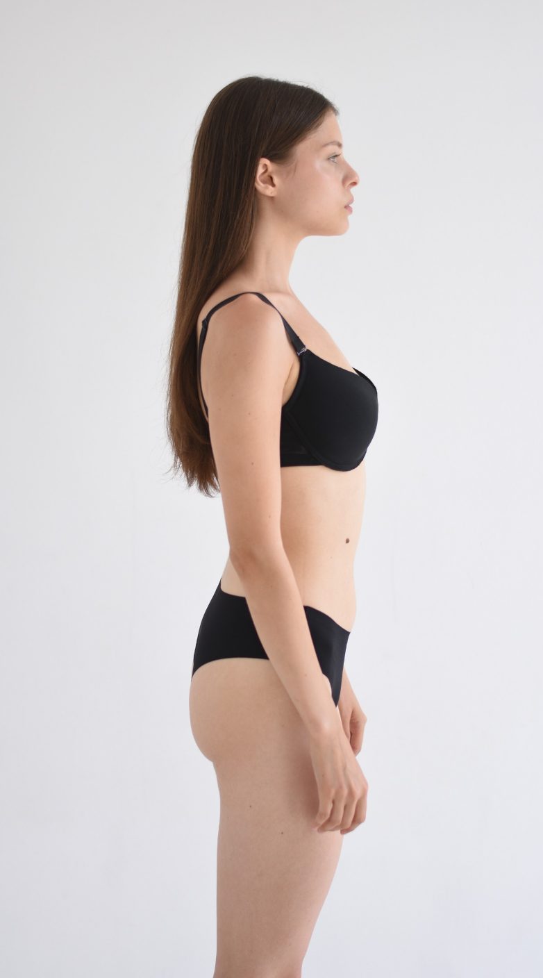 Half-body digital of a female model, other side view, plain background