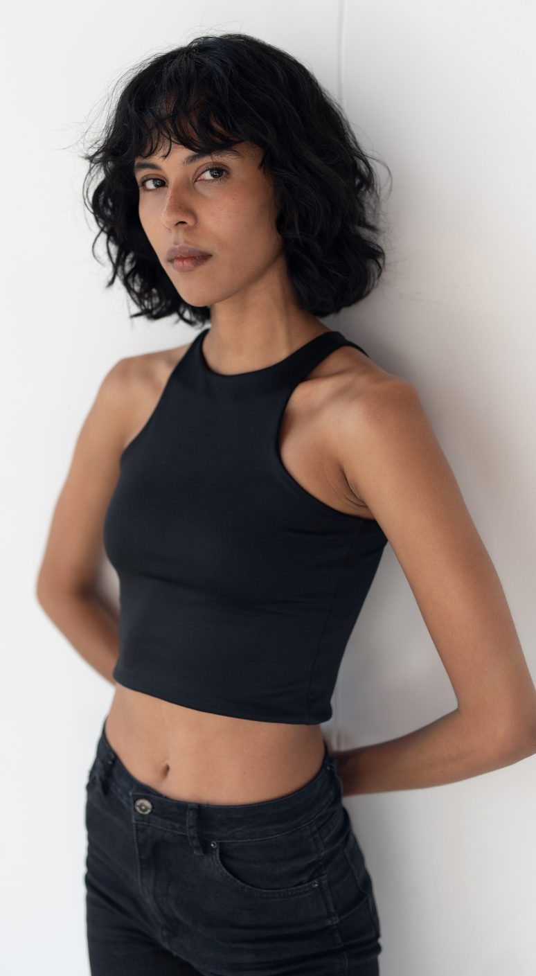 Natural pose option 1 for a female model's digitals, plain background