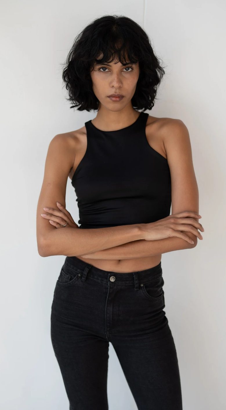 Natural pose option 4 for a female model's digitals, plain background
